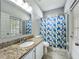 Bright bathroom with a granite vanity, neutral paint, and a window for natural light at 10356 Stone Glen Dr, Orlando, FL 32825