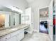 Bright bathroom featuring granite countertop vanity and entry to the main bedroom at 10356 Stone Glen Dr, Orlando, FL 32825