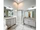 Well-lit bathroom with dual granite vanities, a glass shower, and plenty of space at 10356 Stone Glen Dr, Orlando, FL 32825