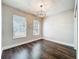 Bedroom with hardwood floors, window with blinds and a modern light fixture at 10356 Stone Glen Dr, Orlando, FL 32825