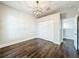 Bedroom with hardwood floors, modern light fixture, and closet doors at 10356 Stone Glen Dr, Orlando, FL 32825