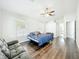 Large bedroom boasts hardwood floors, and natural light from windows, a calming retreat at 10356 Stone Glen Dr, Orlando, FL 32825