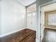 Bright foyer featuring hardwood floors, with view into a room with a window and neutral walls at 10356 Stone Glen Dr, Orlando, FL 32825