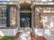 Close up of brick home exterior, featuring a black front door and well manicured landscaping at 10356 Stone Glen Dr, Orlando, FL 32825