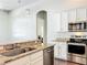 Modern kitchen featuring stainless steel appliances, granite countertops, and white cabinets at 10356 Stone Glen Dr, Orlando, FL 32825