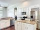 Well-lit kitchen with stainless appliances, central island, and granite countertops at 10356 Stone Glen Dr, Orlando, FL 32825