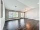 Bright and airy living room with dark hardwood floors and large windows for natural light at 10356 Stone Glen Dr, Orlando, FL 32825