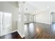 Expansive living room featuring dark wood floors and an arched doorway leading to a bathroom at 10356 Stone Glen Dr, Orlando, FL 32825