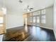 Bright living room with expansive windows, French doors, dark hardwood floors, and a modern ceiling fan at 10356 Stone Glen Dr, Orlando, FL 32825