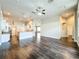 Open floor plan with dark hardwood floors connecting the living room and kitchen at 10356 Stone Glen Dr, Orlando, FL 32825