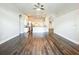 Spacious living room featuring an open floor plan with hardwood floors and modern lighting fixtures at 10356 Stone Glen Dr, Orlando, FL 32825
