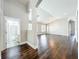Expansive living room featuring dark wood floors and an arched doorway leading to a bathroom at 10356 Stone Glen Dr, Orlando, FL 32825
