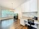 Office area with built-in desk and cabinetry, and a large window at 10356 Stone Glen Dr, Orlando, FL 32825