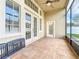 The covered and screened porch offers a tranquil view of the yard beyond at 10356 Stone Glen Dr, Orlando, FL 32825