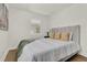 Bright bedroom featuring hardwood floors, an upholstered bed, and natural light from plantation shutters at 108 S Glenwood Ave, Orlando, FL 32803