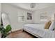 Bedroom featuring hardwood floors, an accent wall painting, and natural light from plantation shutters at 108 S Glenwood Ave, Orlando, FL 32803