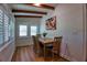 Charming dining room with wood-look floors, exposed beam ceiling, and natural light from the window with shutters at 108 S Glenwood Ave, Orlando, FL 32803