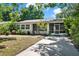 Charming single-story home featuring a screened-in porch and a well-maintained front yard with mature trees at 108 S Glenwood Ave, Orlando, FL 32803