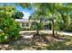 Charming home featuring a screened porch and tropical landscaping at 108 S Glenwood Ave, Orlando, FL 32803