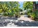A charming single-story home featuring a screened-in porch and a well-maintained front yard with mature trees and long driveway at 108 S Glenwood Ave, Orlando, FL 32803