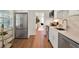 Modern kitchen featuring stainless steel appliances, white cabinets, and an open layout to the living room area at 108 S Glenwood Ave, Orlando, FL 32803