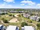 Scenic aerial view of condos nestled within a golf course community, showcasing the expansive green landscape at 1112 Sunset View Cir # 302, Reunion, FL 34747