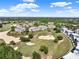 Expansive view of a golf course community featuring multiple condo buildings amidst lush greenery and scenic fairways at 1112 Sunset View Cir # 302, Reunion, FL 34747
