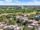 Aerial view of residences surrounded by lush green landscapes, with a hotel visible in the distance at 1112 Sunset View Cir # 302, Reunion, FL 34747