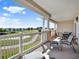 Large balcony with seating and scenic views of a golf course and community buildings at 1112 Sunset View Cir # 302, Reunion, FL 34747