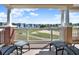 Relaxing balcony with outdoor chairs offering expansive views of the manicured golf course at 1112 Sunset View Cir # 302, Reunion, FL 34747