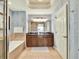 Spacious bathroom with double vanity, a soaking tub, and blue accent walls at 1112 Sunset View Cir # 302, Reunion, FL 34747