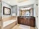 Elegant bathroom with double vanity, a soaking tub, and refined decor at 1112 Sunset View Cir # 302, Reunion, FL 34747