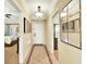 Bright and inviting hallway with tiled flooring, neutral walls, and views into bedrooms and living spaces at 1112 Sunset View Cir # 302, Reunion, FL 34747
