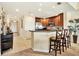Modern kitchen features dark wood cabinets, stainless steel appliances, and an island with barstool seating at 1112 Sunset View Cir # 302, Reunion, FL 34747
