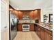 Modern kitchen with stainless steel appliances, granite countertops, and rich wood cabinetry for a luxurious feel at 1112 Sunset View Cir # 302, Reunion, FL 34747