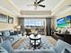 Living room with access to balcony, comfortable seating, stylish decor, and a ceiling fan at 1112 Sunset View Cir # 302, Reunion, FL 34747