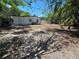 Wide backyard space with wood and white fences, mature trees, and a white home exterior at 1125 W 8Th St, Lakeland, FL 33805