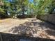Large backyard featuring a wood fence and mature trees, perfect for outdoor activities at 1125 W 8Th St, Lakeland, FL 33805