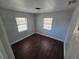 Inviting bedroom with two bright windows and dark tile flooring at 1125 W 8Th St, Lakeland, FL 33805
