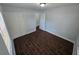 Light bedroom with white walls and closet, and dark floors at 1125 W 8Th St, Lakeland, FL 33805