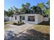 Charming single-story home featuring a well-manicured lawn, walkway, and inviting curb appeal at 1125 W 8Th St, Lakeland, FL 33805