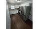 Spacious kitchen with white cabinets, stainless steel appliances, and wood-look tile flooring at 1125 W 8Th St, Lakeland, FL 33805
