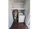 Laundry room including washer, water heater, utility shelves, and wood-look tile flooring at 1125 W 8Th St, Lakeland, FL 33805