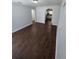 Spacious living room with hard wood floors, neutral colors, and archway leading to kitchen at 1125 W 8Th St, Lakeland, FL 33805