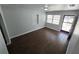 Inviting living room featuring gray walls and dark-toned wood-look tile floors and a window at 1125 W 8Th St, Lakeland, FL 33805