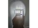 Cozy living room with gray walls, dark floors, and arched doorway at 1125 W 8Th St, Lakeland, FL 33805