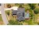 Home with solar panels, screened-in pool, and surrounding mature trees, as seen from above at 11401 Willow Stowe Ln, Windermere, FL 34786