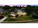 Expansive aerial view of a pristine home with lush landscaping, mature trees, and a sprawling green lawn at 11401 Willow Stowe Ln, Windermere, FL 34786