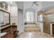 Well-lit bathroom featuring a large soaking tub, a walk-in shower, and double vanity sinks at 11401 Willow Stowe Ln, Windermere, FL 34786