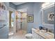 Blue-walled bathroom featuring a glass shower enclosure and a stylish vanity at 11401 Willow Stowe Ln, Windermere, FL 34786